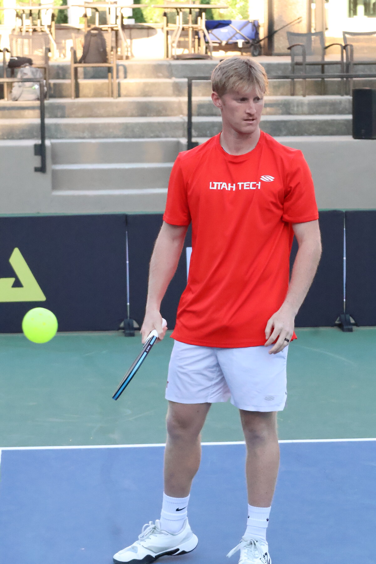 Coach Clayton Boydston playing pickleball in a red Utah Tech shirt